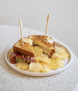 Club Sandwich z kurczakiem, bekonem, sałatą, pomidorem i domowymi chipsami w Lastriko – najlepsze śniadanie w Krakowie.